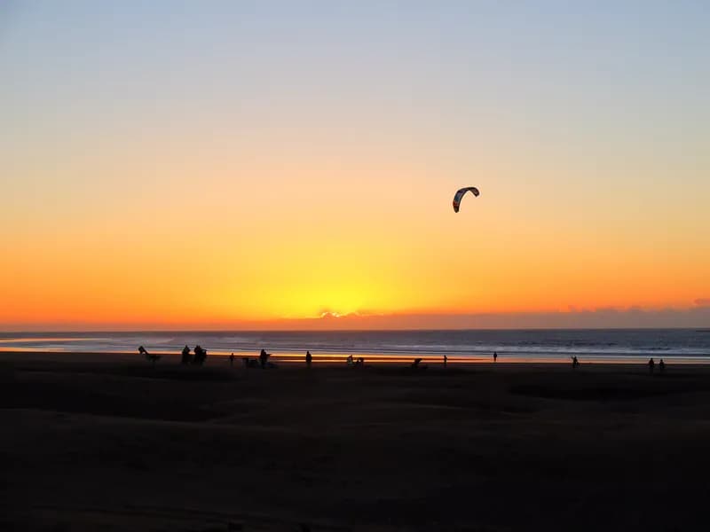 A kite against the setting sun on Essaouira beach