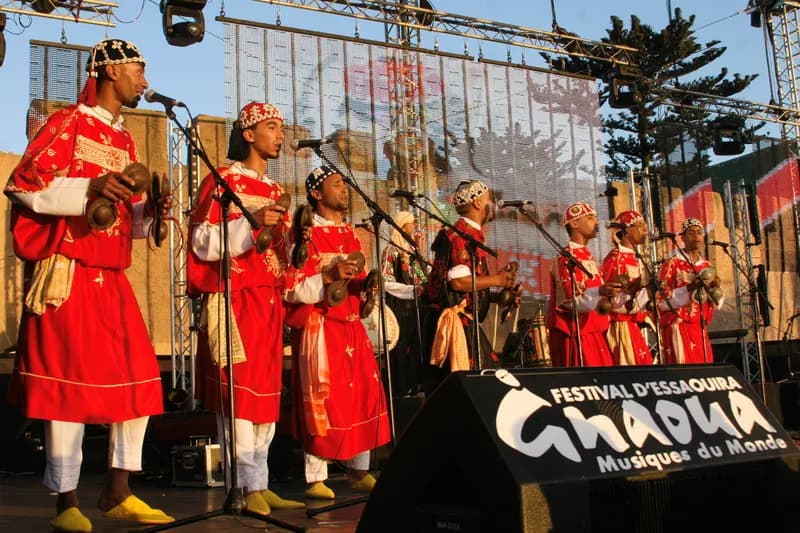 Gnaoua musicians in costume on stage during the Essaouira festival